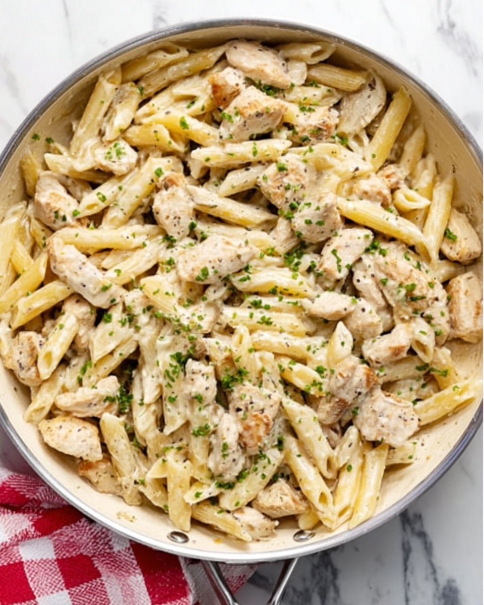 The image shows ingredients arranged neatly on a white marbled surface. There is a small glass bowl filled with light golden olive oil, and next to it, a small bowl containing creamy white crème fraîche or cream. A dish holds light pink chopped chicken pieces, while a white bowl is filled with thin, wide yellow pappardelle pasta. Thinly sliced brown and white mushrooms are placed in a small white bowl, with several peeled white garlic cloves on the side. A small bowl contains grated pale yellow parmesan cheese for serving. A lemon wedge with bright yellow zest sits nearby, and fresh green parsley sprigs add a pop of color. The arrangement is simple and clean, showcasing each ingredient clearly, photo taken with an iphone --ar 4:5 --v 7