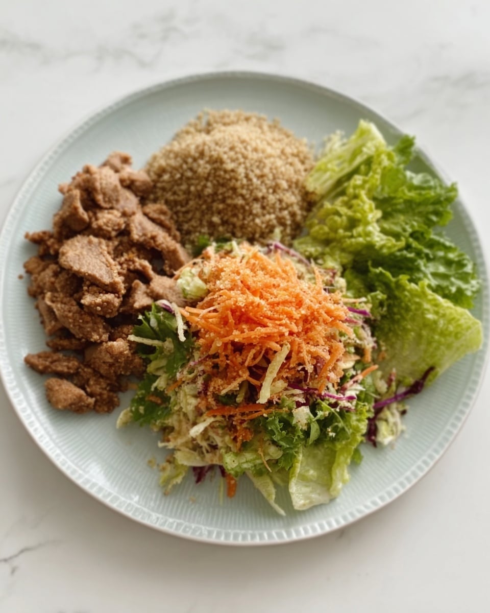 The image shows a white plate holding three sections of food arranged neatly. On the left side, there are small chunks of cooked brown meat with a slightly rough texture. In the middle, next to the meat, there is a small mound of light brown fluffy grains, probably quinoa. On the right side of the plate, there is a fresh salad made of green and pale lettuce leaves topped with shredded orange and light purple vegetables. The plate is set on a white marbled surface. Photo taken with an iphone --ar 4:5 --v 7