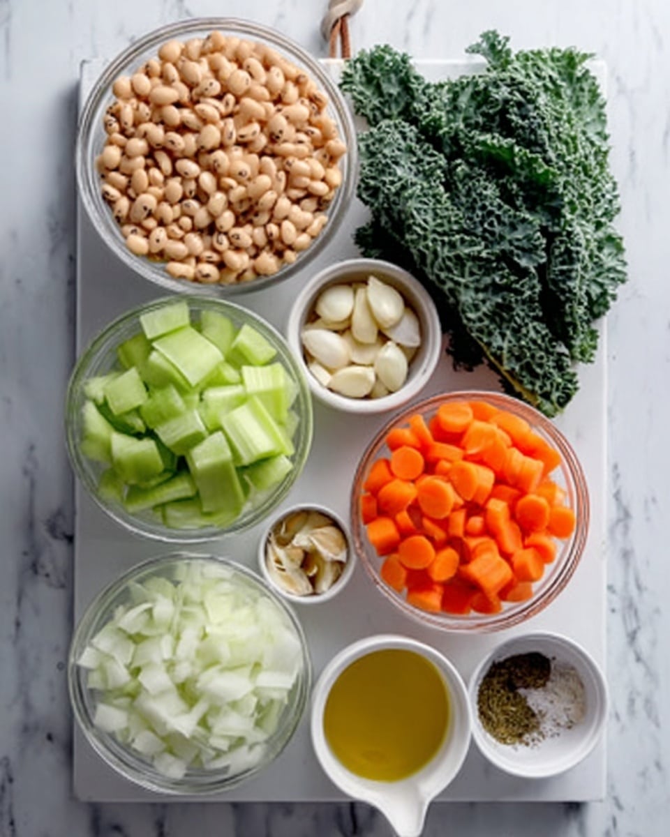 The image shows several clear glass bowls and small white containers arranged neatly on a white marbled surface. One large bowl at the top holds light tan beans with dark spots, showing a smooth texture. Below it, another large bowl contains pale green celery slices, glossy and fresh-looking. Next to it, a large bowl is filled with bright orange carrot slices, smooth and round. Another large bowl contains finely chopped white onions with a slightly translucent look. There are two small white bowls, one holds several whole garlic cloves, and the other contains a mix of dried herbs or spices in dark green and brown shades. A small white cup with golden yellow olive oil is also present. On the right side, fresh dark green kale leaves add a rough texture and rich color to the scene. The whole arrangement is on a white marbled surface. Photo taken with an iphone --ar 4:5 --v 7