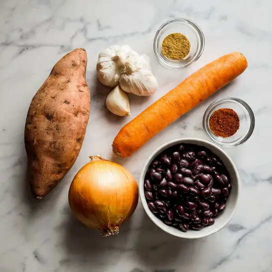 The image shows a group of raw ingredients placed on a white marbled surface. There are two sweet potatoes with a rough orange-brown skin, one medium-sized carrot with a smooth bright orange color, and one whole onion with light brown skin. Three garlic cloves with pale skin are next to two small clear glass bowls holding spices; one spice is a rusty red color and the other is a yellow-brown color. A white bowl is filled with shiny, dark black beans resting on the white marbled surface. photo taken with an iphone --ar 4:5 --v 7