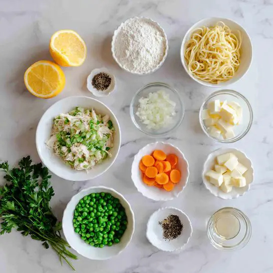 The image shows various ingredients arranged in white bowls and small clear dishes on a white marbled surface. There are two lemon halves next to a white bowl with shredded chicken at the bottom right. Above the chicken is a small bowl of green peas, and next to it are finely chopped green celery and a few slices of orange carrot in their own white bowls. There is a small bowl of white flour near the top center and a bowl filled with egg noodles at the top right. Around these bowls, small dishes hold white chopped onions, minced garlic cloves, butter cubes, and a small glass of clear liquid. Two small bowls contain black pepper and dried herbs. Finally, a bunch of fresh green parsley is placed at the bottom left. photo taken with an iphone --ar 4:5 --v 7