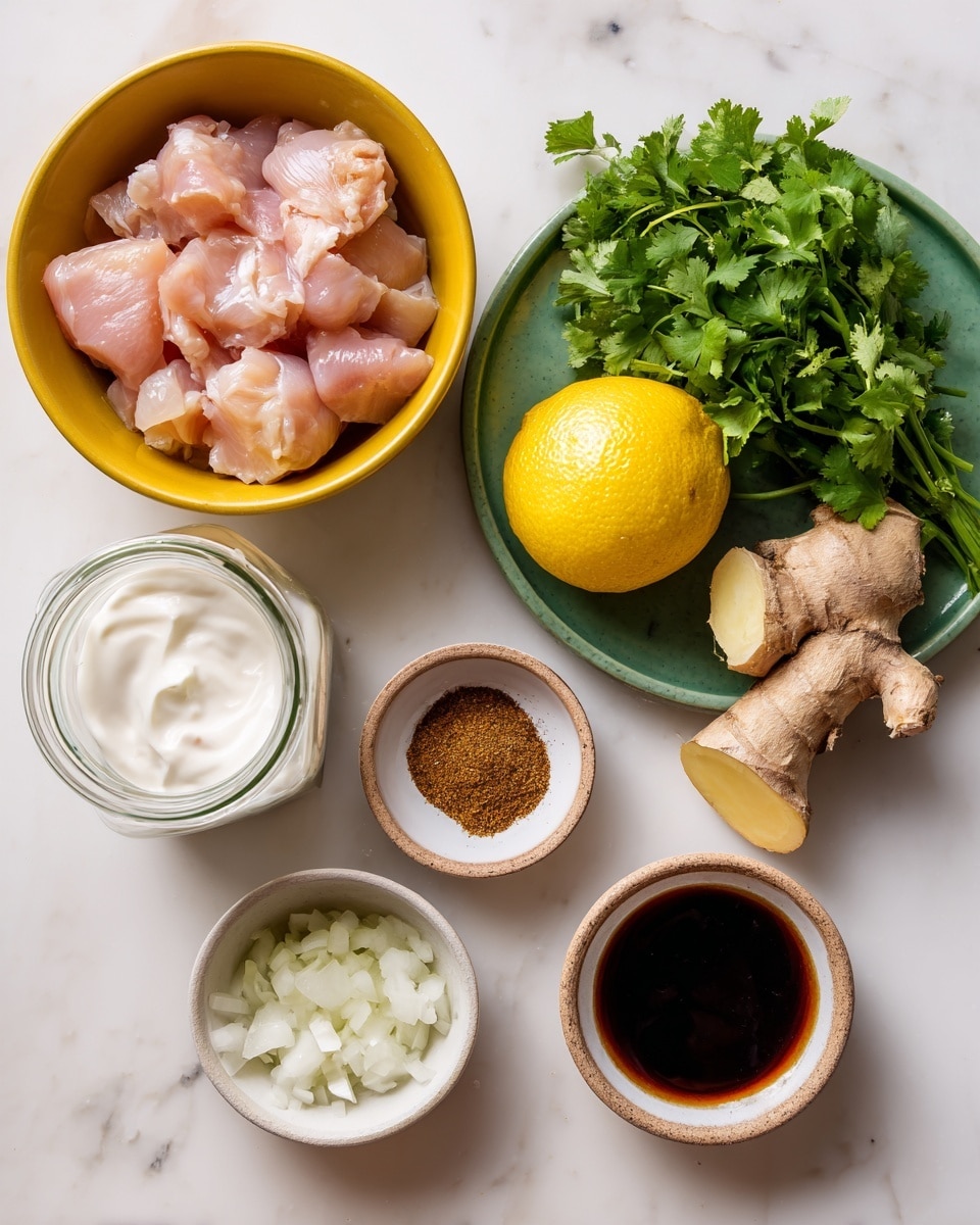 The image shows a collection of raw ingredients arranged on a white marbled surface. In the top left is a yellow bowl filled with light pink raw chicken pieces, next to it on the right is a green plate holding a pale yellow halved lemon, a piece of beige ginger root, a small bunch of fresh green cilantro, and a small glass jar filled with white yogurt. Below the chicken bowl are two small white bowls, one with finely chopped white onion and the other with ground brown spices. To the right of these is another small white bowl containing a dark brown liquid sauce. The colors are bright and fresh, with clear textures visible on each ingredient. photo taken with an iphone --ar 4:5 --v 7
