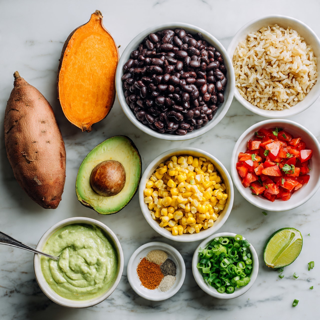 The image shows a flat lay of fresh ingredients arranged neatly on a white marbled surface. There is one whole and one halved sweet potato with orange flesh at the top left. Below them, a white bowl filled with black beans sits next to another white bowl of cooked brown rice at the top right. Near the center, there are small white bowls holding bright red chopped tomatoes, green chopped scallions, and golden yellow corn kernels. A halved avocado with a large seed is placed at the lower left. A woman's hand is holding a spoon inside a white bowl of creamy green sauce at the bottom left corner. Spices, including ground cumin and paprika, rest in a small white bowl near the center. A lime half with a bright green interior is positioned at the lower right. The whole setting has a clean and fresh look, perfect for making a healthy meal. photo taken with an iphone --ar 4:5 --v 7