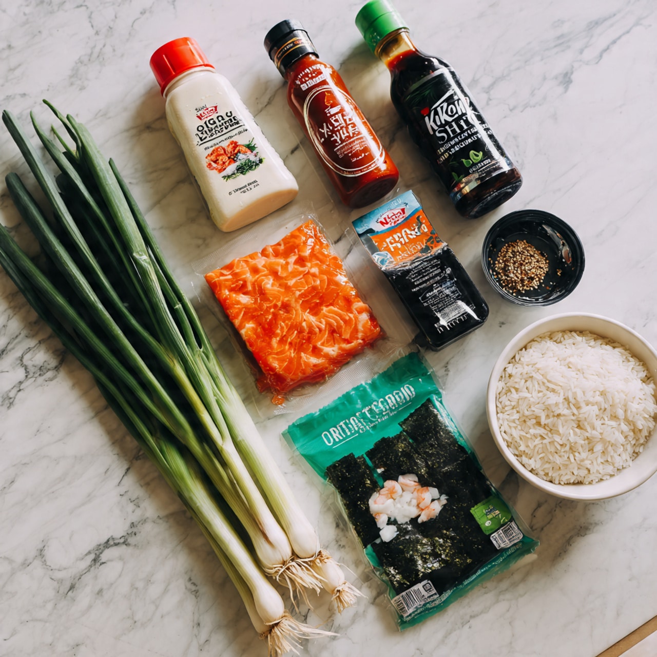 The image shows various ingredients for a sushi dish arranged on a white marbled surface. Starting from the top row, there are five bottles and jars including a white bottle of Kewpie mayonnaise with a red cap, a clear bottle of sriracha hot chili sauce with a green cap, a bottle of organic seasoned rice vinegar with a red cap, a black bottle of unagi sauce, and a small container of rice seasoning furikake. Below these, from left to right, is a bright orange piece of raw salmon, a packet of imitation crab meat with white and orange pieces visible on the package, and a green packet of organic roasted seaweed snack. On the bottom left, there are multiple long green onions with white bases. To the right, there is a white bowl filled with uncooked white rice grains. The photo taken with an iphone --ar 4:5 --v 7