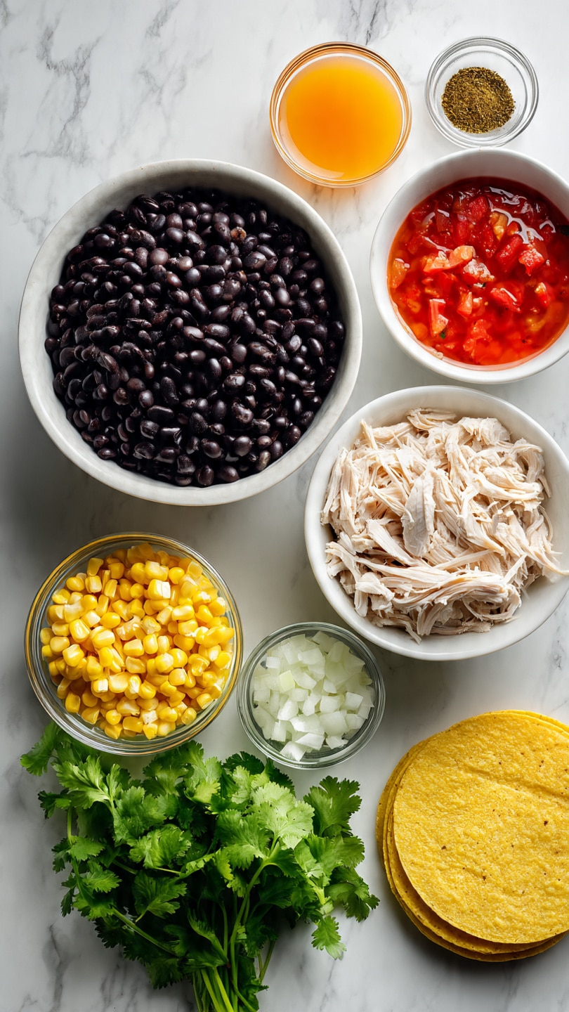The image shows a top view of several ingredients arranged on a white marbled surface. In the center, a large white bowl is filled with dark black beans, and to the right, another white bowl holds shredded light-colored chicken. Below the bowls, there is a bunch of fresh green cilantro with visible leaves and stems placed over diced white onions. To the left, a clear glass bowl full of bright yellow corn kernels contrasts with an opened can of red diced tomatoes. Near the top right, a glass container with orange broth or juice sits beside small glass bowls containing brown powder and dried green herbs. On the bottom right, there is a stack of yellow corn tortillas. The scene is bright and colorful, with clear textures and natural lighting. Photo taken with an iphone --ar 4:5 --v 7