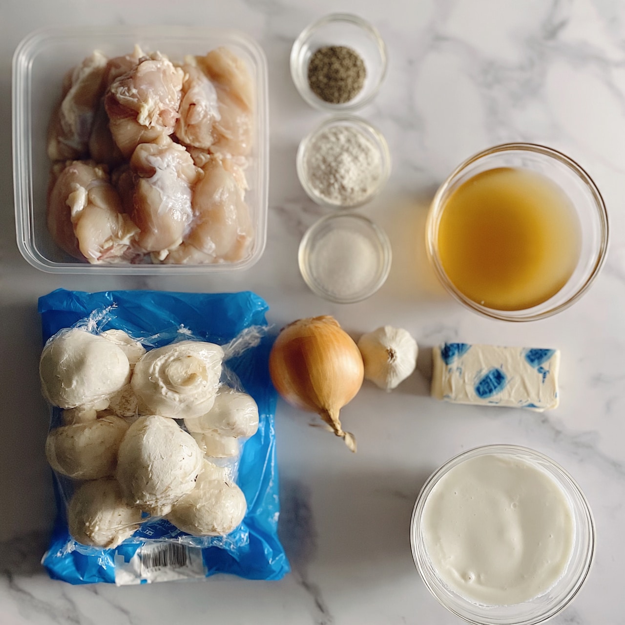 square image This image shows ingredients for cooking arranged neatly on a white marbled textured surface. At the top left is a clear rectangular container holding several raw, pale pink chicken pieces. Below it, there is a blue package of whole white mushrooms with a plastic wrap and a label. To the right of the mushrooms, there is a whole yellow onion and a small white garlic bulb placed close together. Above these, there are three small clear bowls in a vertical line holding black pepper, white flour, and salt from top to bottom. To the right, a clear bowl filled with golden broth and below that a stick of butter wrapped in paper with some blue text on it. Finally, at the bottom right corner, there is a clear round bowl filled with white cream. photo taken with an iphone --ar 4:5 --v 7